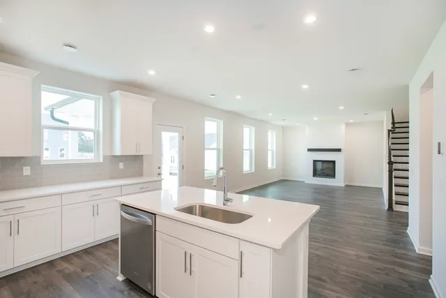 a kitchen with a sink stove and cabinets