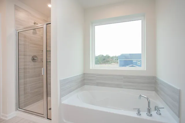 a white bath tub sitting next to a window