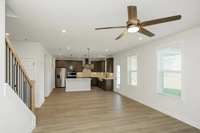 a view of living room with furniture and ceiling fan