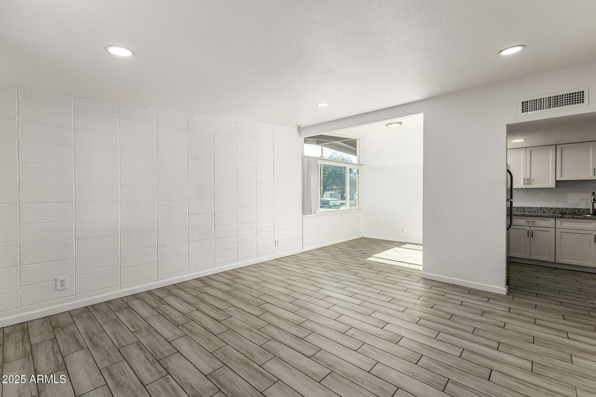 6708 East Cheery Lynn Road, Unit B Scottsdale, AZ 85251 - Photo 12 of 35 a view of empty room with wooden floor and kitchen