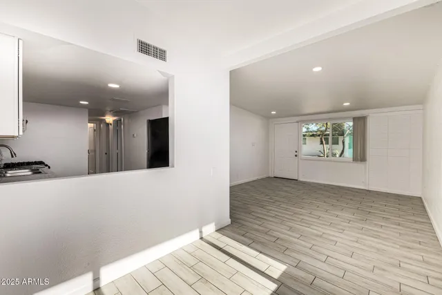 a kitchen with stainless steel appliances granite countertop a stove a sink and a refrigerator