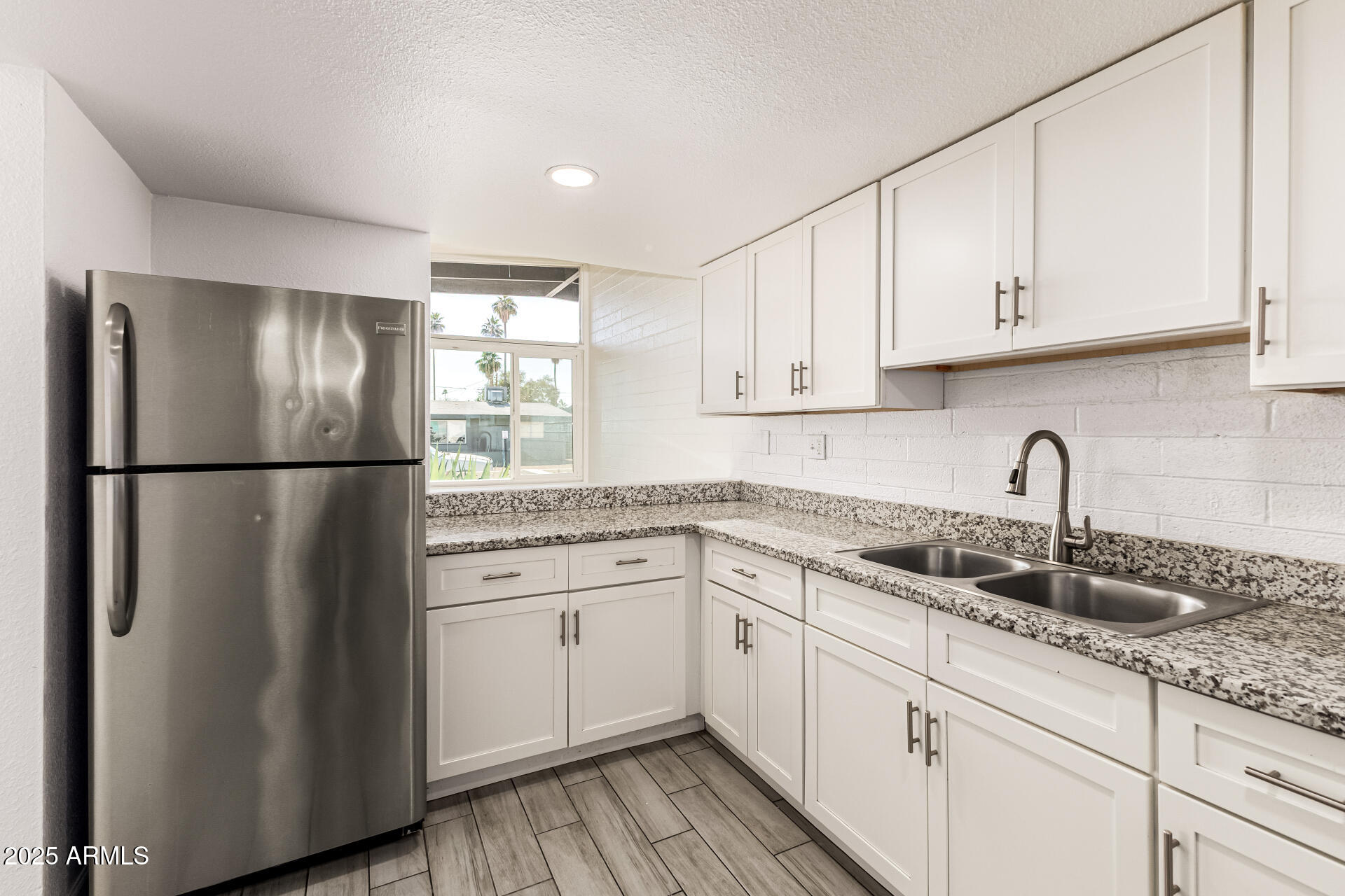 6708 East Cheery Lynn Road, Unit B Scottsdale, AZ 85251 - Photo 19 of 35 a kitchen with a refrigerator sink and cabinets