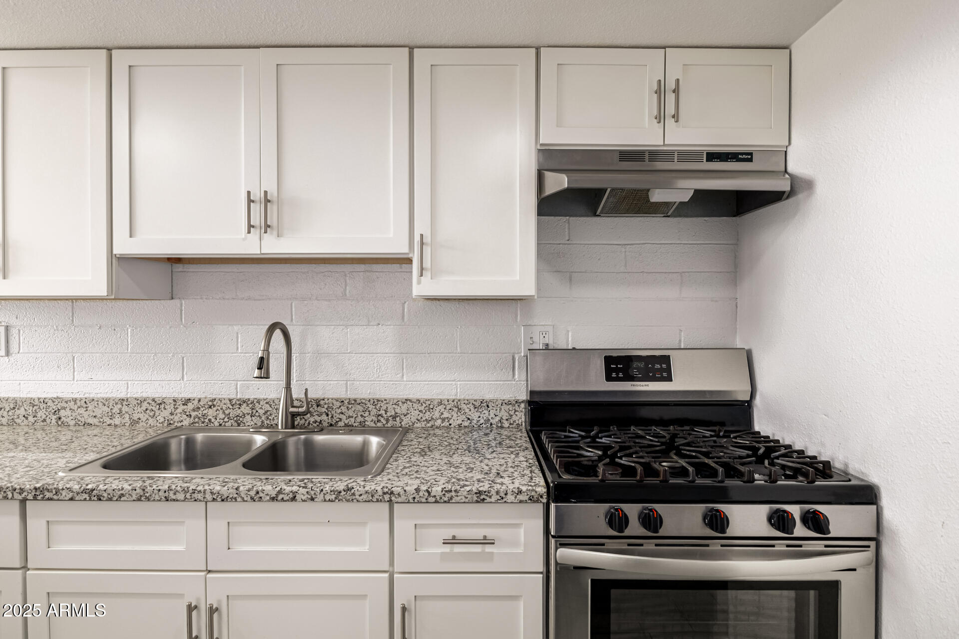 6708 East Cheery Lynn Road, Unit B Scottsdale, AZ 85251 - Photo 20 of 35 a kitchen with granite countertop white cabinets and a stove