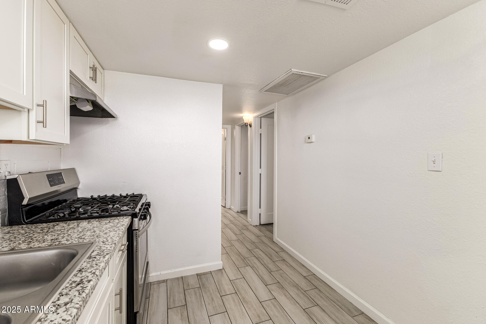 6708 East Cheery Lynn Road, Unit B Scottsdale, AZ 85251 - Photo 21 of 35 a kitchen with a refrigerator and a stove top oven