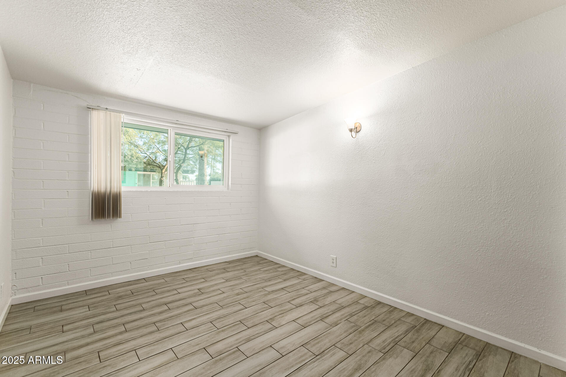 6708 East Cheery Lynn Road, Unit B Scottsdale, AZ 85251 - Photo 22 of 35 wooden floor in an empty room with a window