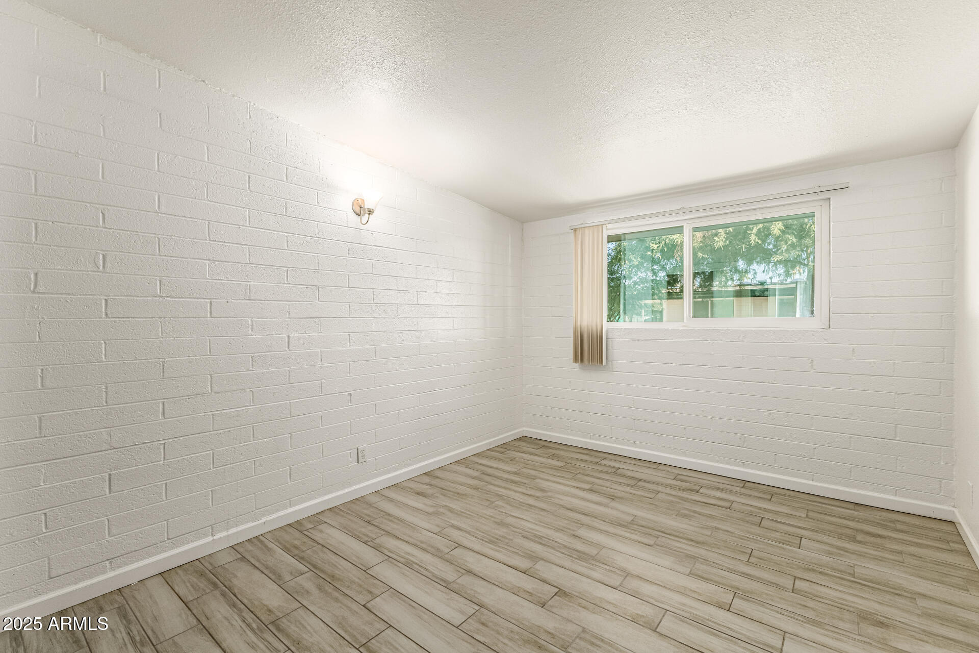 6708 East Cheery Lynn Road, Unit B Scottsdale, AZ 85251 - Photo 25 of 35 wooden floor in an empty room with a window