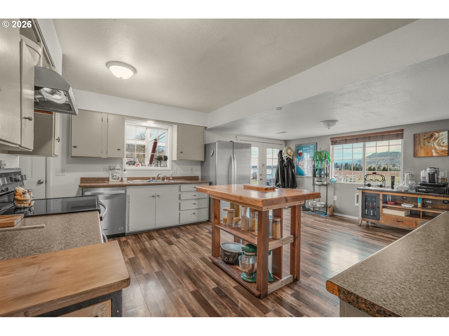 156 Damron Road Mossyrock, WA 98564 - Photo 11 of 34 a kitchen with stainless steel appliances kitchen island granite countertop a table chairs sink and cabinets