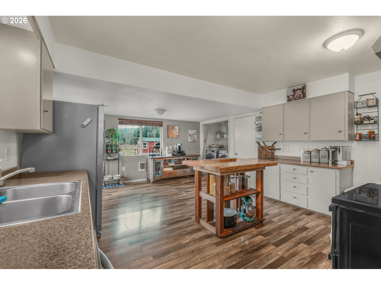 156 Damron Road Mossyrock, WA 98564 - Photo 13 of 34 a kitchen with a table chairs refrigerator and cabinets