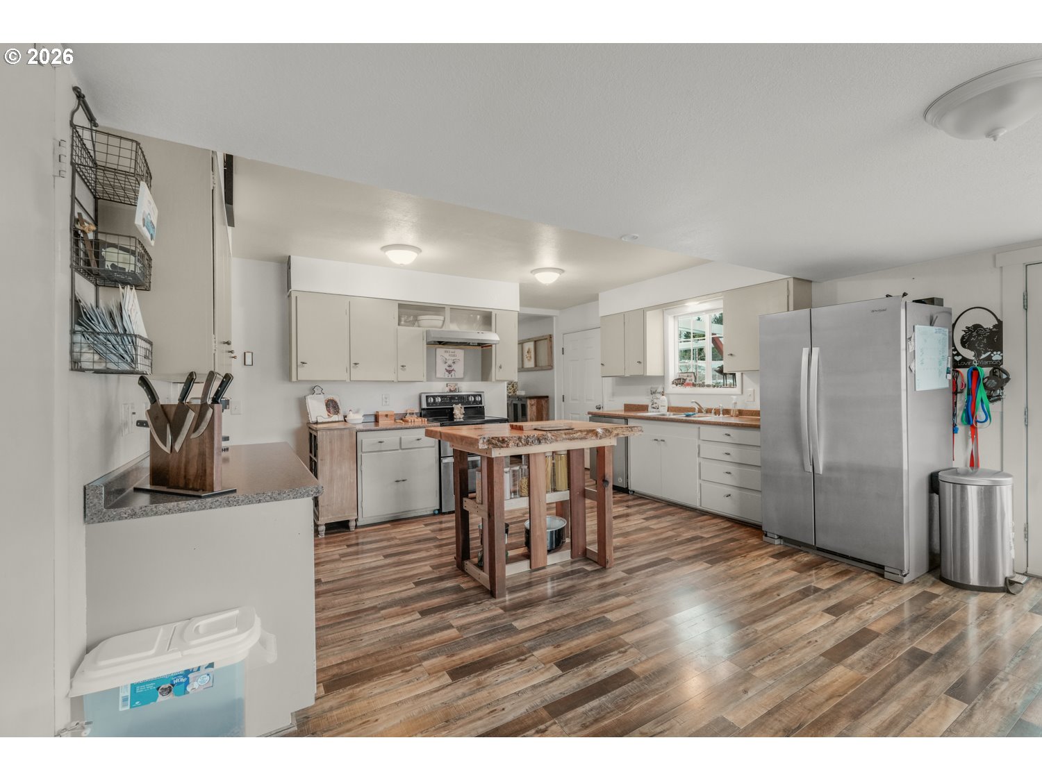156 Damron Road Mossyrock, WA 98564 - Photo 14 of 34 a kitchen with a table chairs refrigerator and cabinets