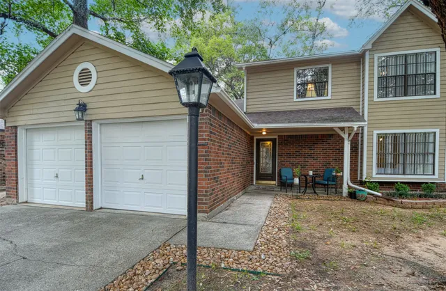 a view of a house with a yard and garage