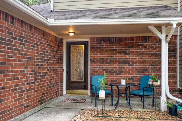 a view of a door with a chairs and table in a patio