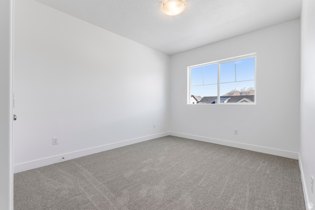 58 South Crimson Way, Unit 306 Mapleton, UT 84664 - Photo 15 of 24 Bright interior space featuring a multi-pane window, flush-mount ceiling light, light-colored walls, white baseboards, and grey carpeting