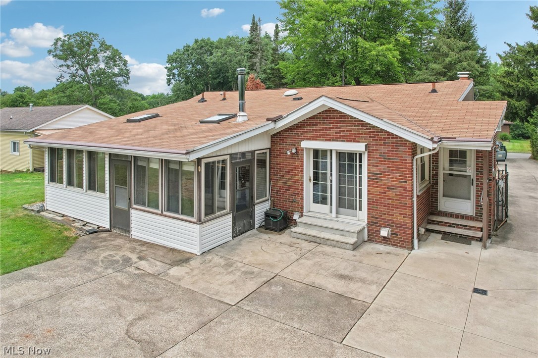 3873 Baumberger Road Stow, OH 44224 - Photo 42 of 50 Back of property with a patio and a sunroom
