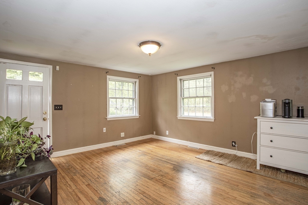 175 Summer Street Norwell, MA 02061 - Photo 3 of 29 a view of an empty room with a window and wooden floor