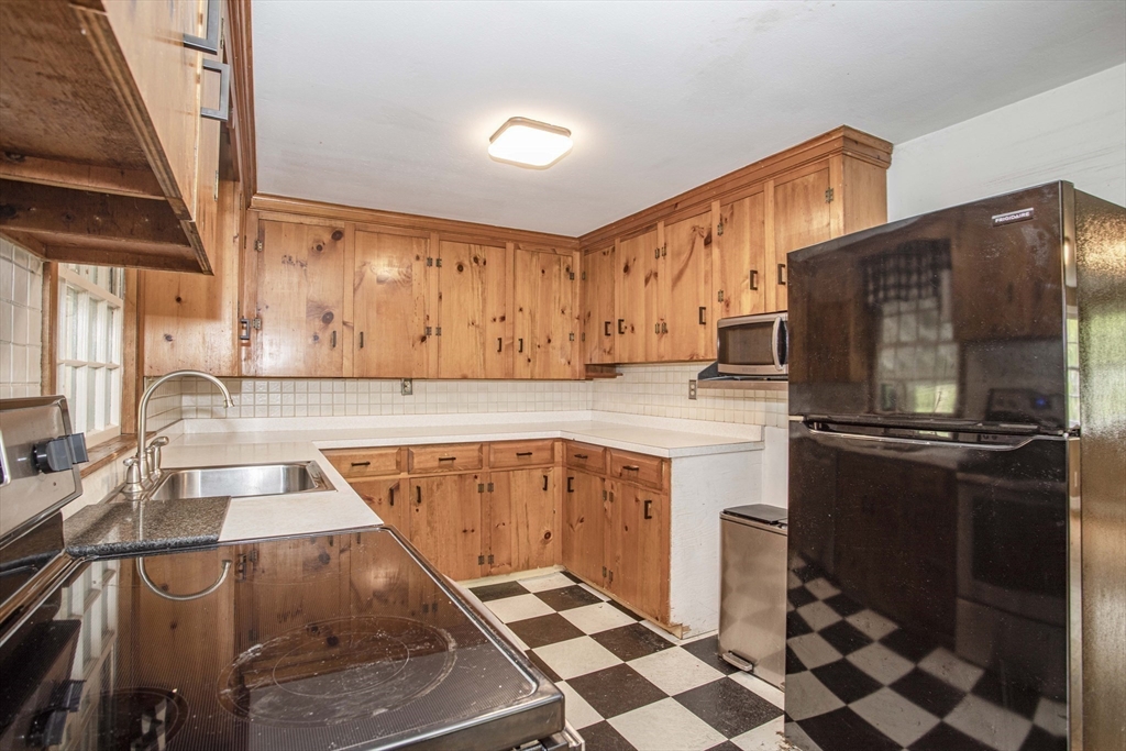 175 Summer Street Norwell, MA 02061 - Photo 6 of 29 a kitchen with a refrigerator and a sink