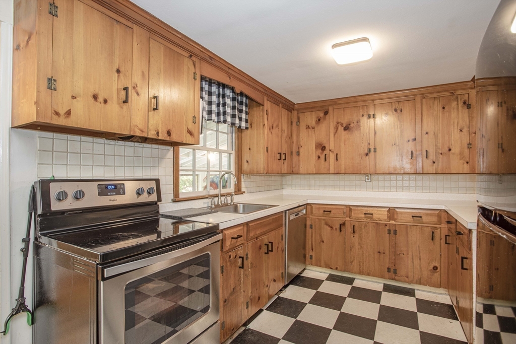 175 Summer Street Norwell, MA 02061 - Photo 7 of 29 a kitchen with a sink a stove and cabinets