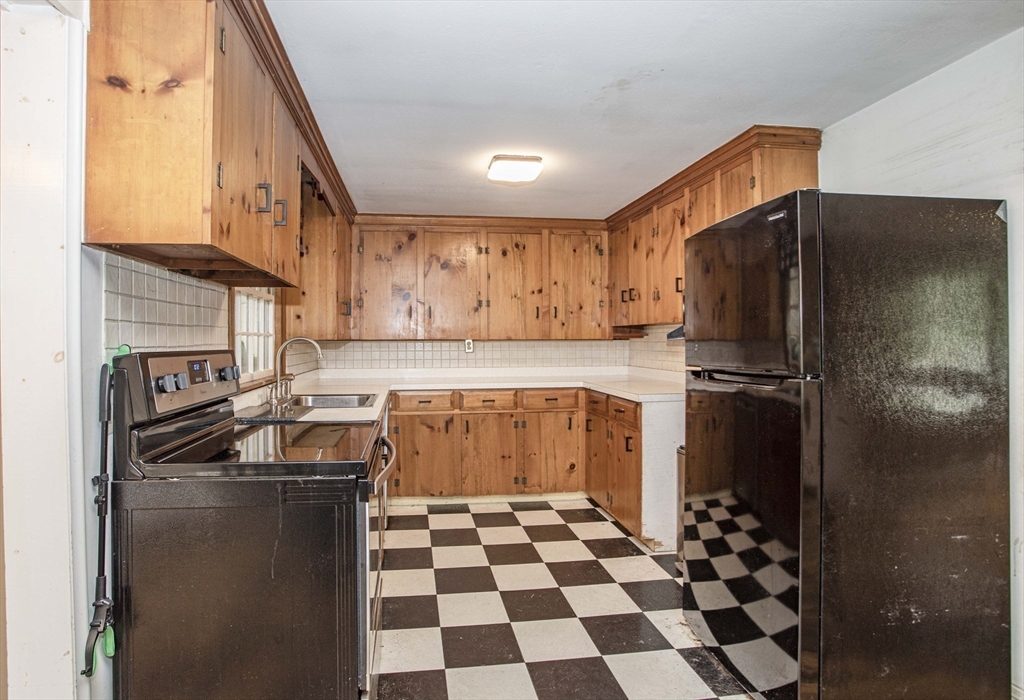 175 Summer Street Norwell, MA 02061 - Photo 8 of 29 a kitchen with a refrigerator and a sink