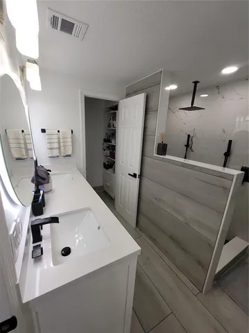 a white toilet sitting next to a bathroom sink