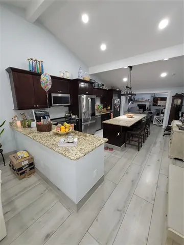 a kitchen with a stove a refrigerator and a sink