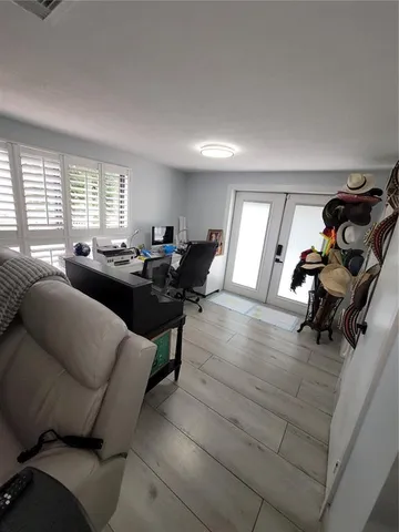 a living room with furniture and a gym