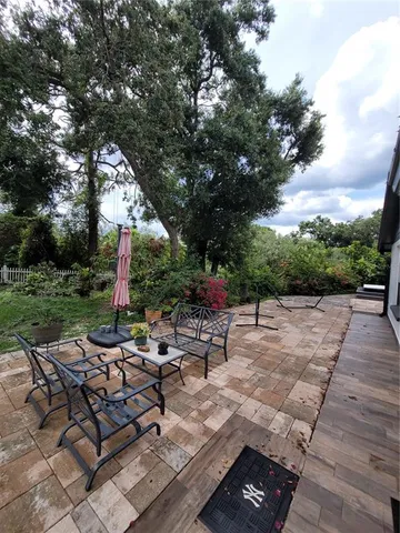 a view of a grey house with a yard