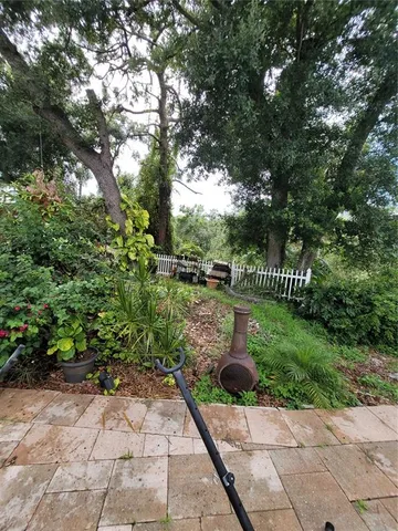 a view of a backyard with sitting area