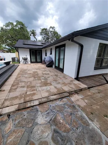 a view of a yard with plants and a bench