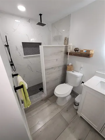 a bathroom with a toilet and a shower