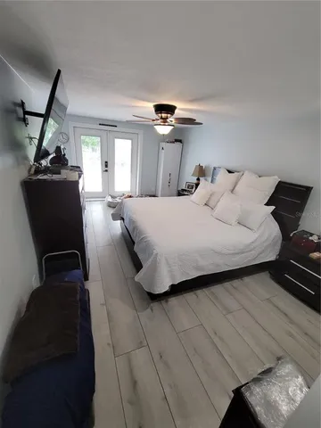 a bedroom with a bed and a mirror