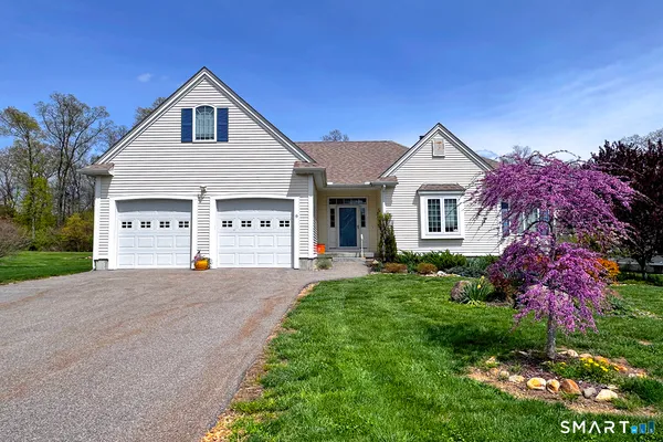 a front view of a house with a garden and yard