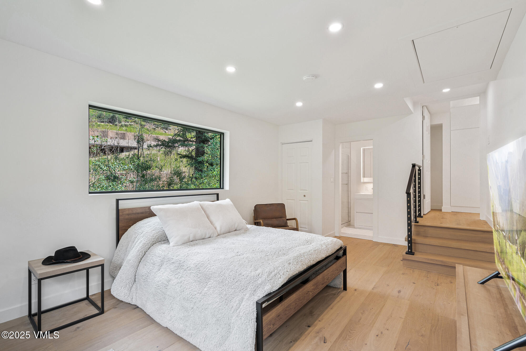 4545 Big Horn Road Vail, CO 81657 - Photo 32 of 49 a bedroom with a large bed and a painting on the wall