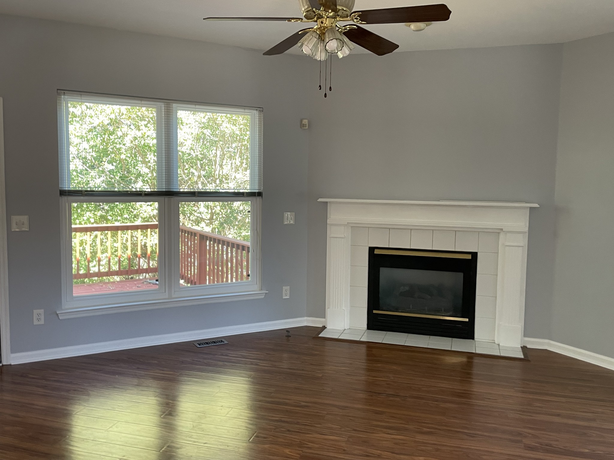 313 Compass Point Hermitage, TN 37076 - Photo 9 of 11 a view of an empty room with wooden floor fireplace and a window