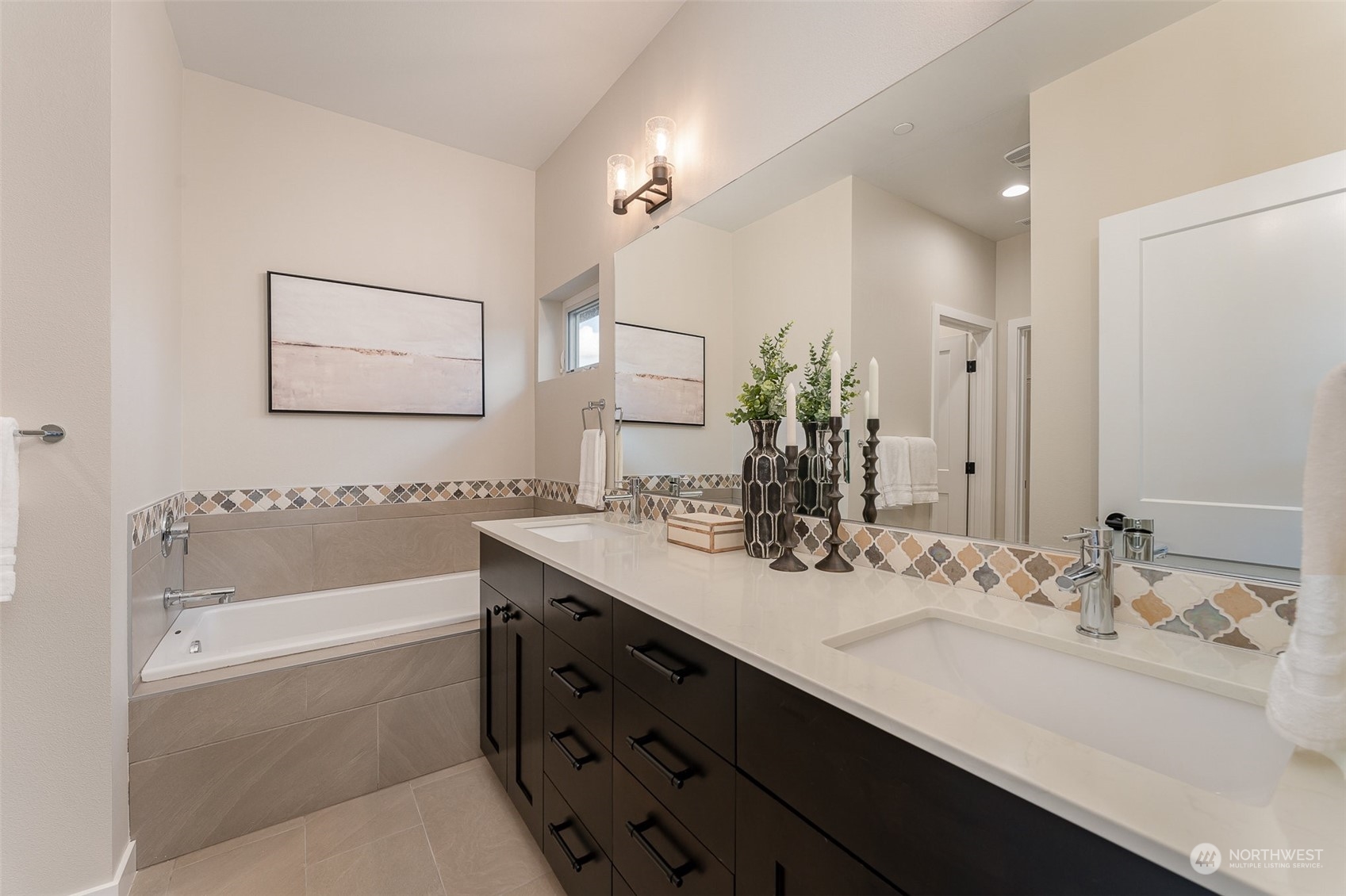 1074 Southwest Collier Place Issaquah, WA 98027 - Photo 12 of 36 a bathroom with a tub a double vanity sink and mirror