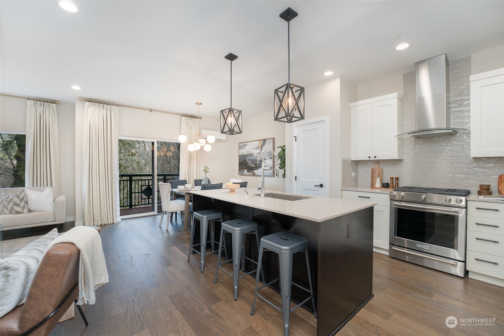 1074 Southwest Collier Place Issaquah, WA 98027 - Photo 3 of 36 a kitchen with stainless steel appliances kitchen island a table chairs sink and stove top oven