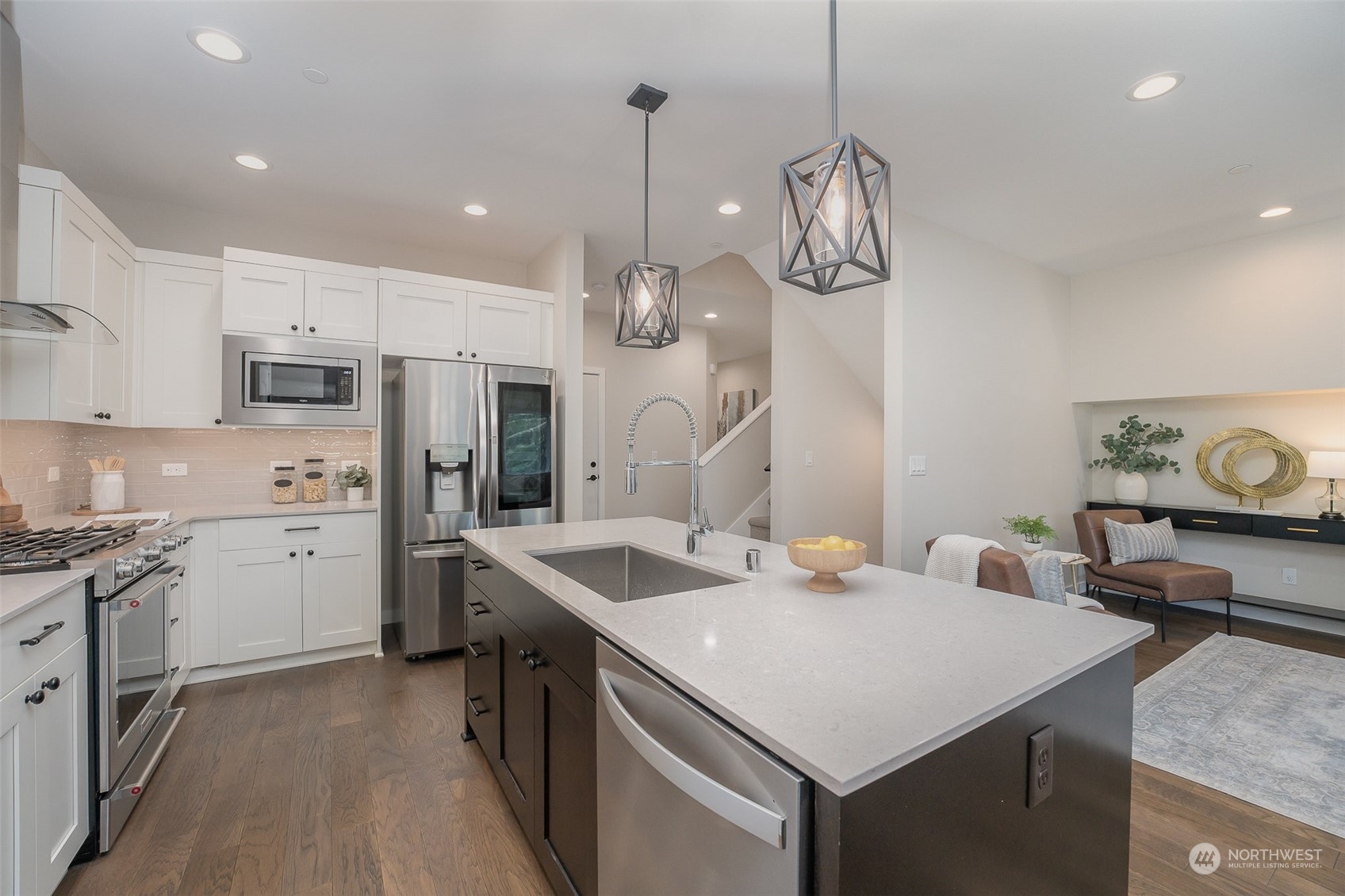 1074 Southwest Collier Place Issaquah, WA 98027 - Photo 4 of 36 a kitchen with a sink a refrigerator and chairs