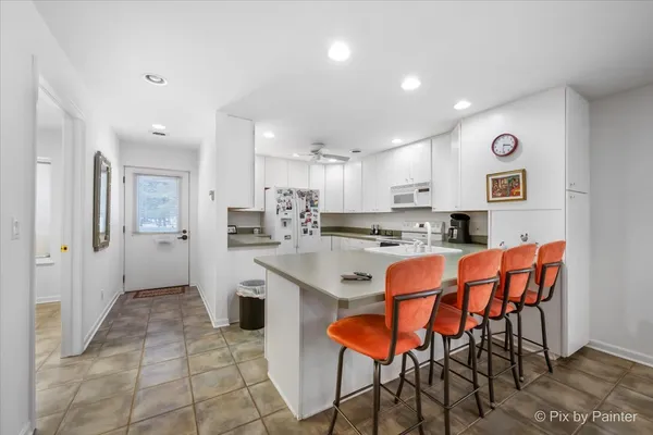 a living room with furniture and kitchen view