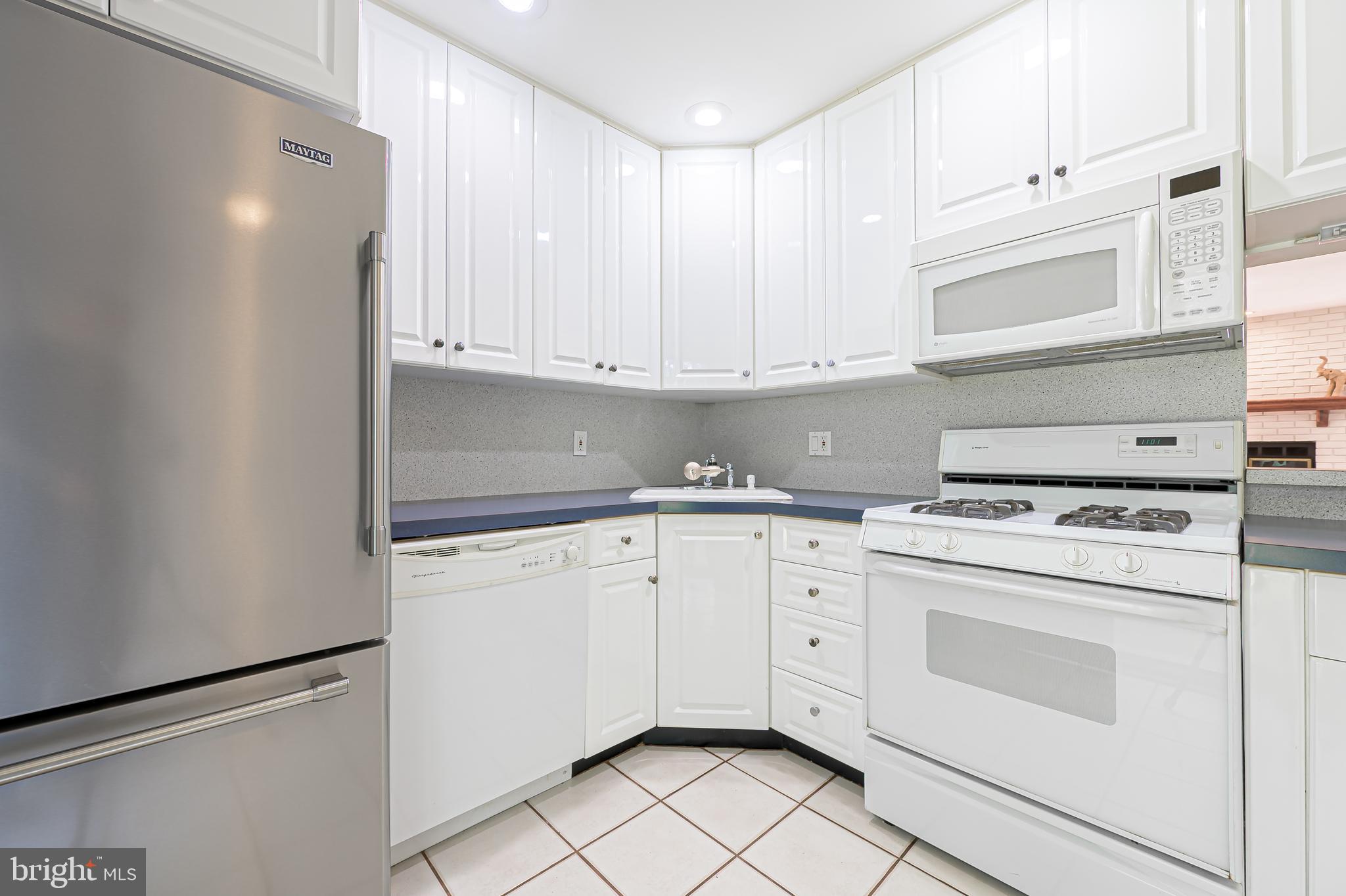 298 Mattix Run Galloway Township, NJ 08205 - Photo 12 of 36 a kitchen with granite countertop white cabinets and white appliances
