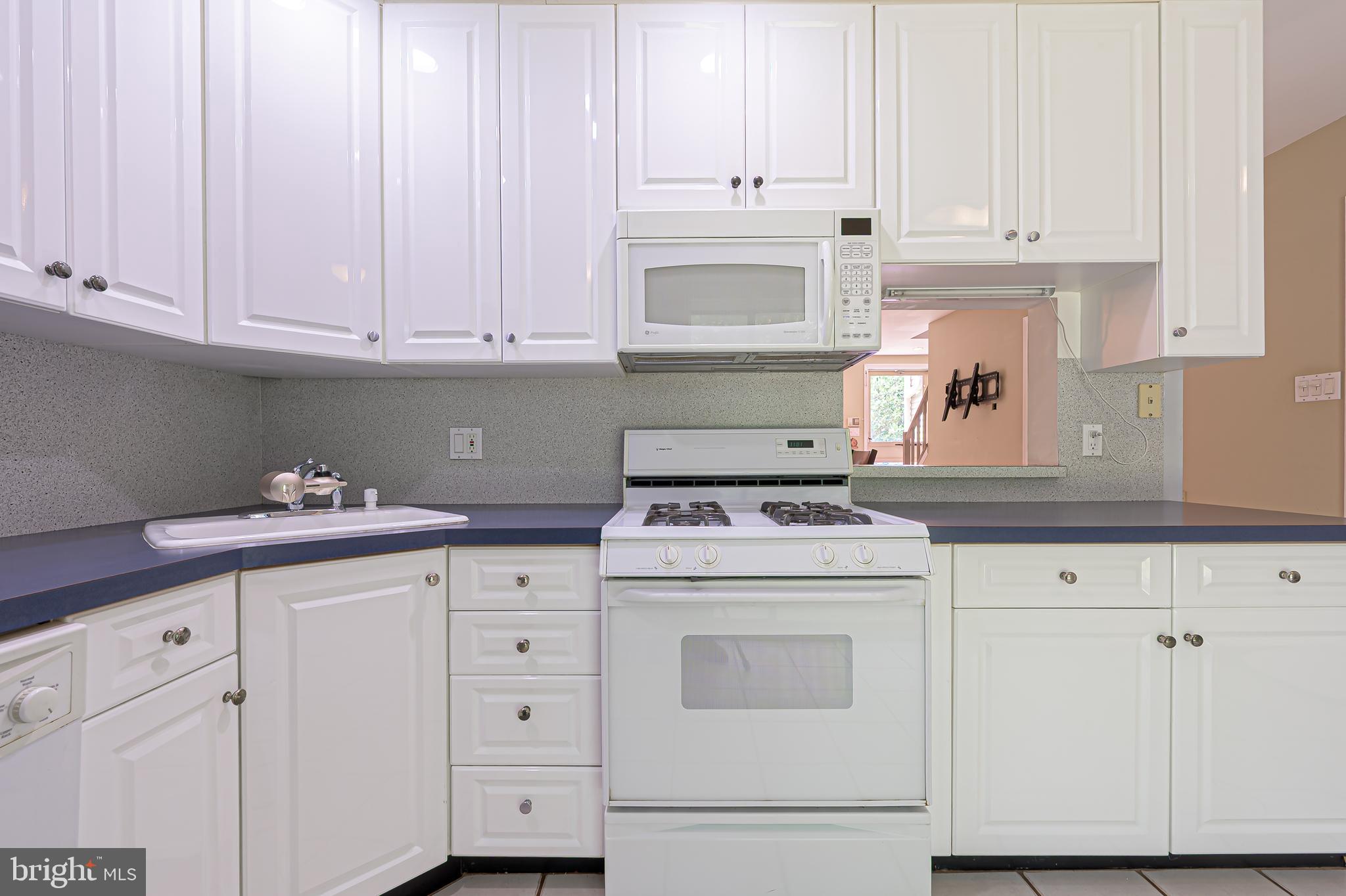 298 Mattix Run Galloway Township, NJ 08205 - Photo 13 of 36 a kitchen with granite countertop white cabinets and white appliances