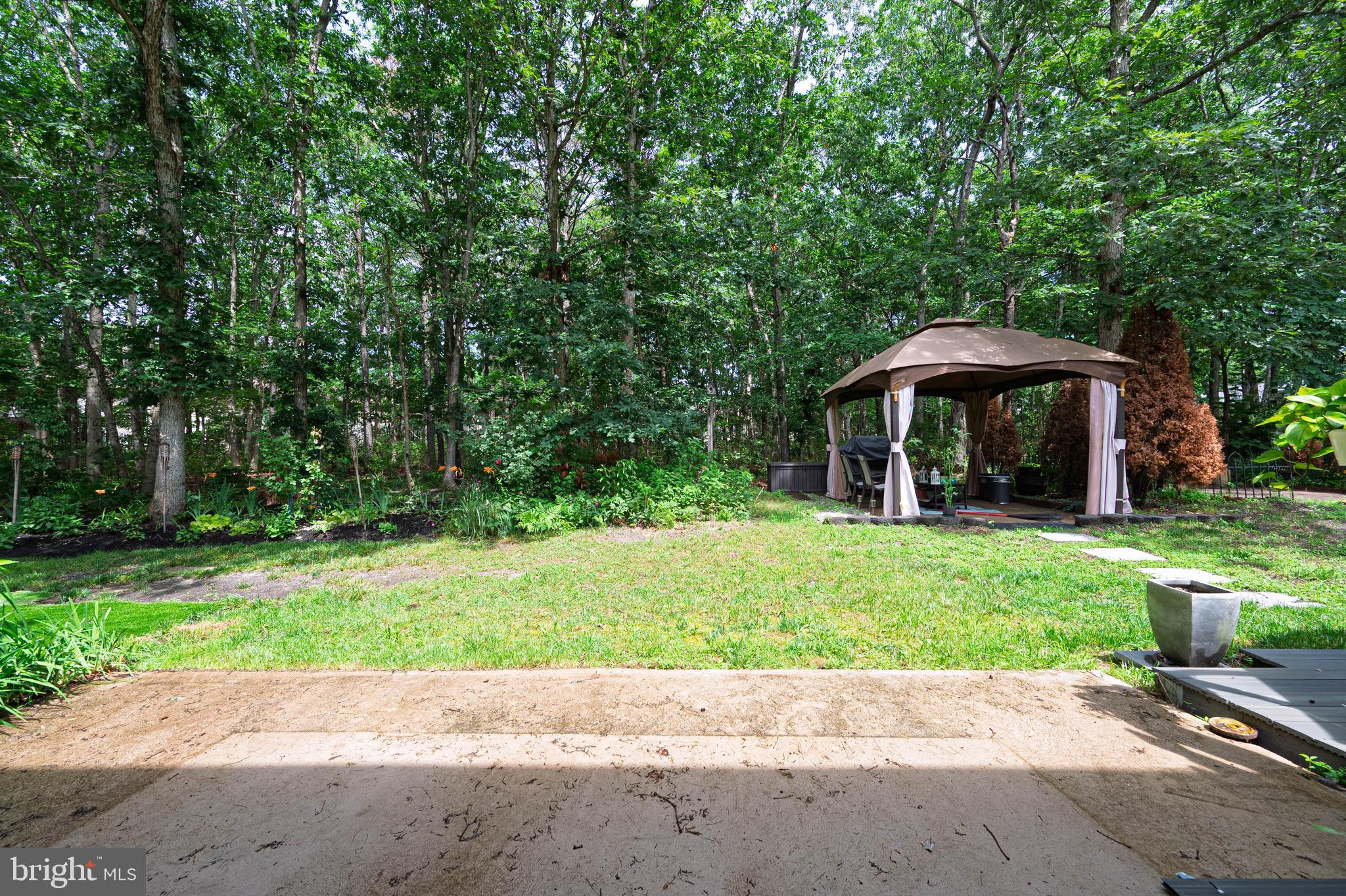 298 Mattix Run Galloway Township, NJ 08205 - Photo 25 of 36 a backyard of a house with a garden and barbeque oven