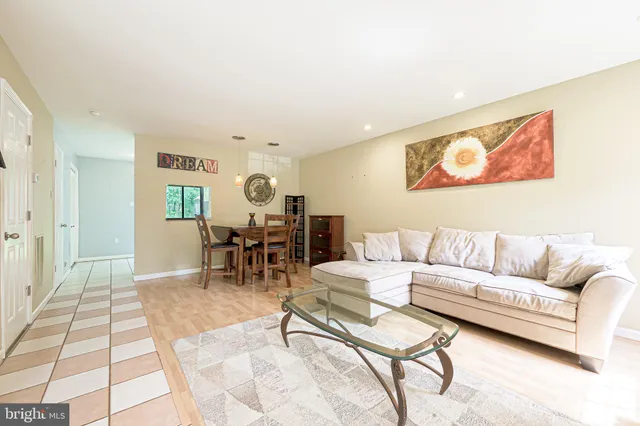 a living room with furniture and dining area