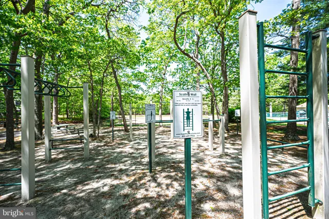 a sign board with a house and yard