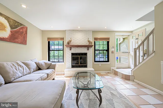 a living room with furniture fireplace and window