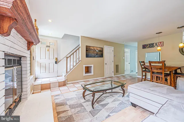a living room with furniture a piano and a bookshelf