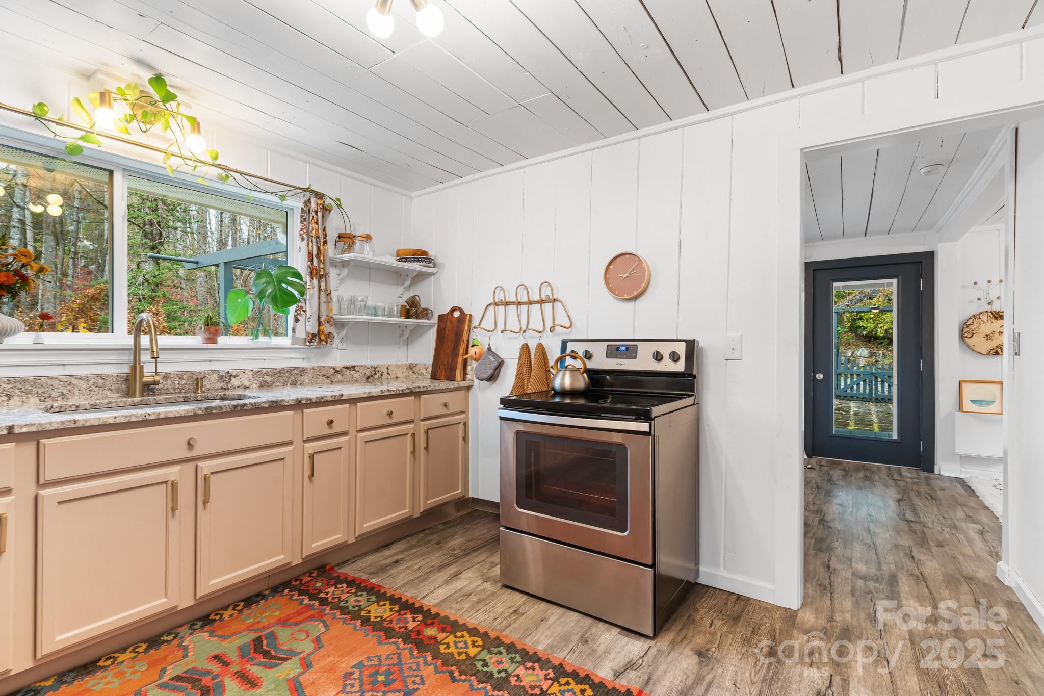 200 Nimitz Drive Brevard, NC 28712 - Photo 15 of 44 a kitchen with granite countertop a stove and a sink
