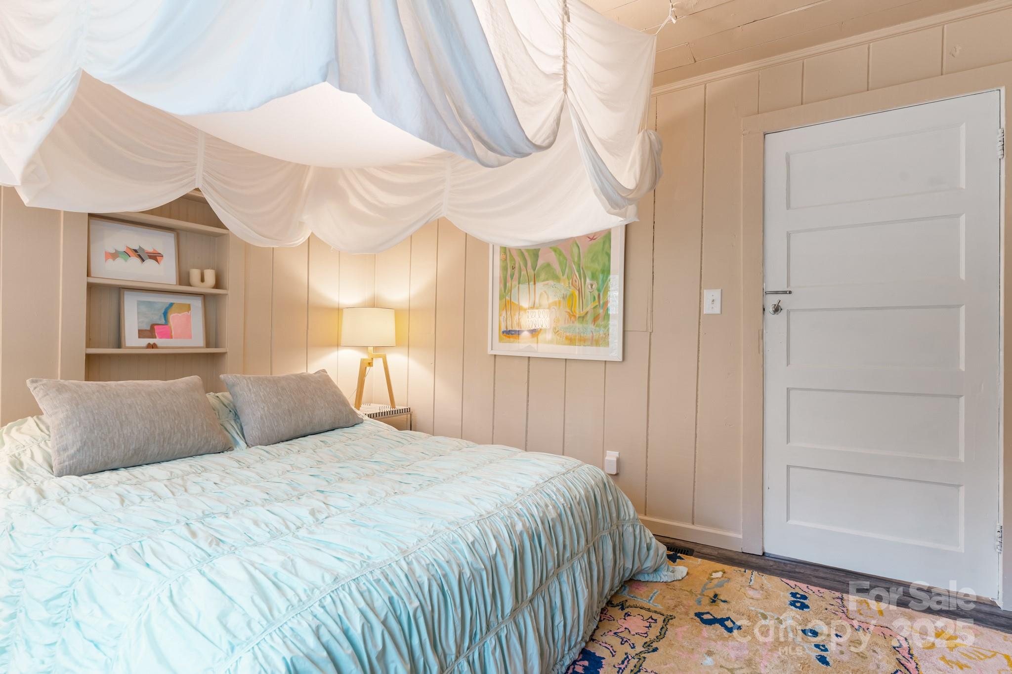 200 Nimitz Drive Brevard, NC 28712 - Photo 18 of 44 a bedroom with a bed and a painting on the wall