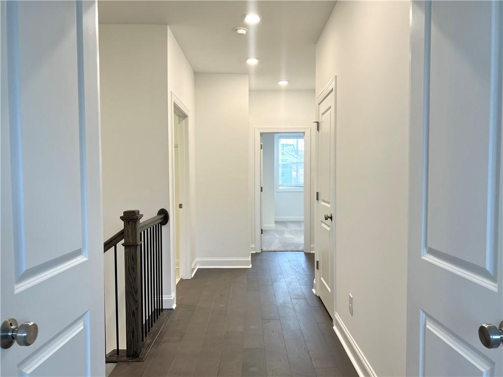 3347 Goodwin Park Suwanee, GA 30024 - Photo 17 of 28 a view of a hallway with wooden floor and staircase