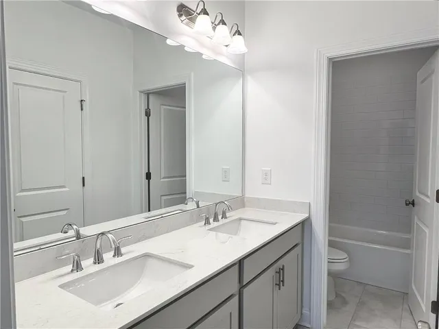 a bathroom with a sink vanity tub and shower