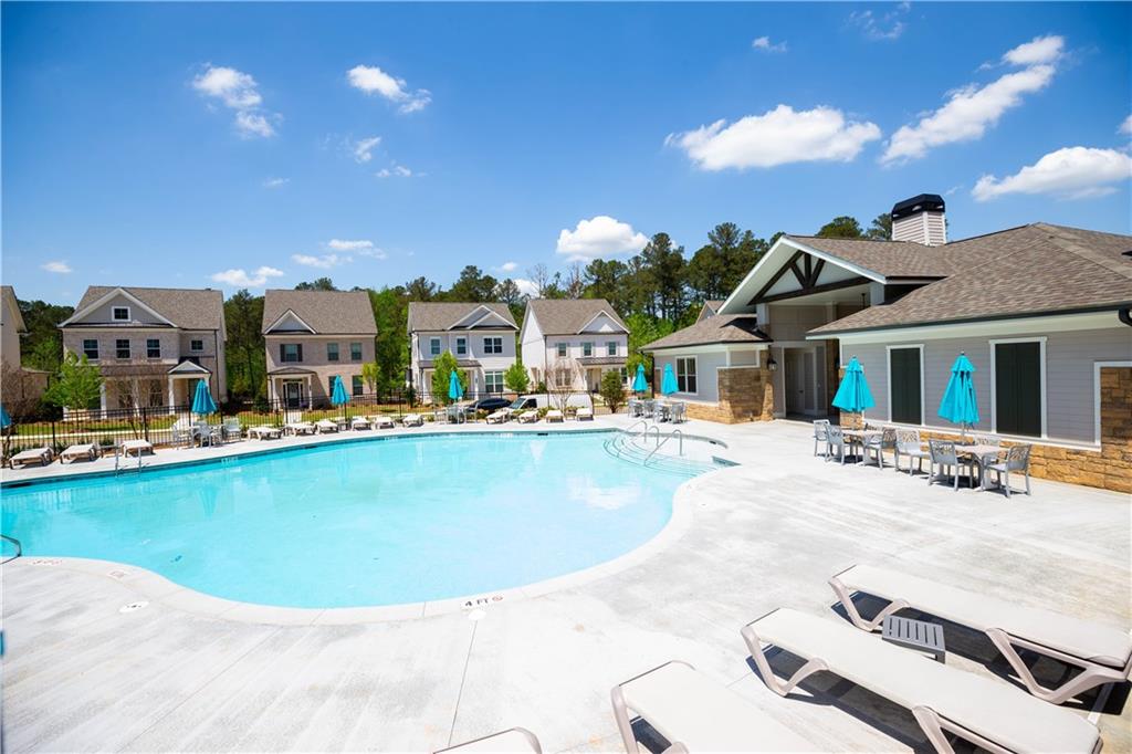 3347 Goodwin Park Suwanee, GA 30024 - Photo 27 of 28 a view of a swimming pool with a lawn chairs under an umbrella