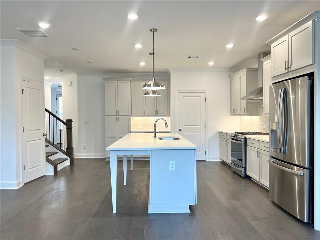 3347 Goodwin Park Suwanee, GA 30024 - Photo 5 of 28 a kitchen with granite countertop a sink appliances and cabinets