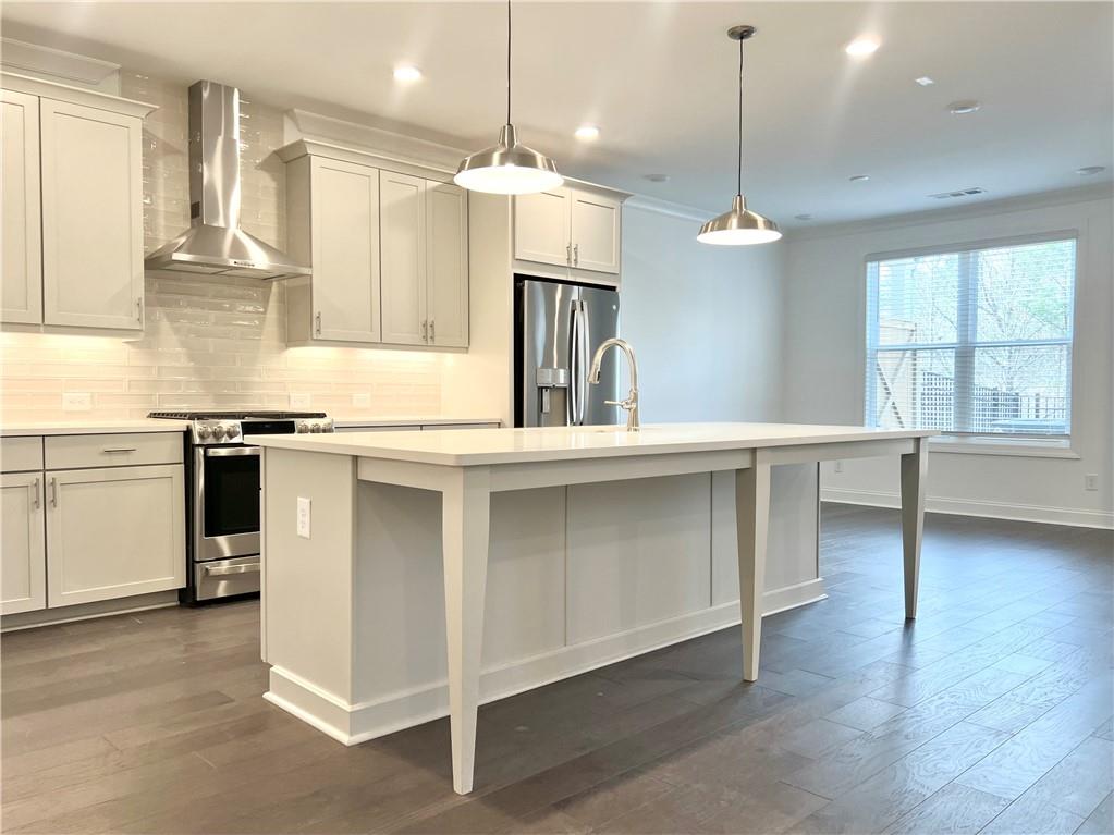 3347 Goodwin Park Suwanee, GA 30024 - Photo 8 of 28 a kitchen with stainless steel appliances granite countertop a stove a sink and a refrigerator